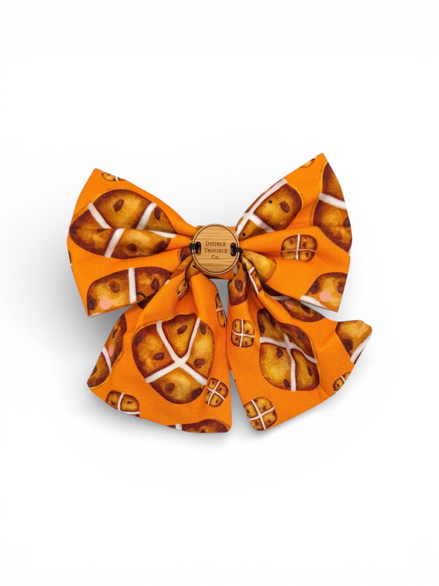 Orange sailor bow with a pattern of hot crossed buns