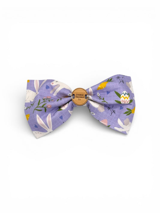 Floral-patterned Easter themed bow tie with a wooden tag on a white background