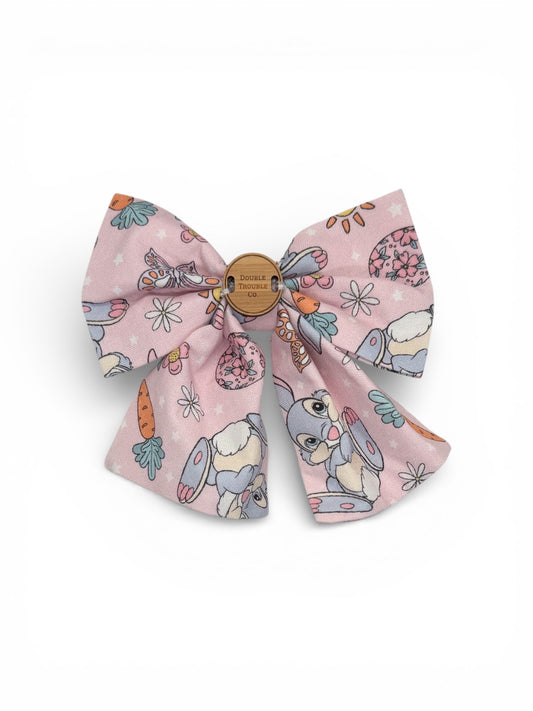 Large pink bow with cartoon characters on a white background